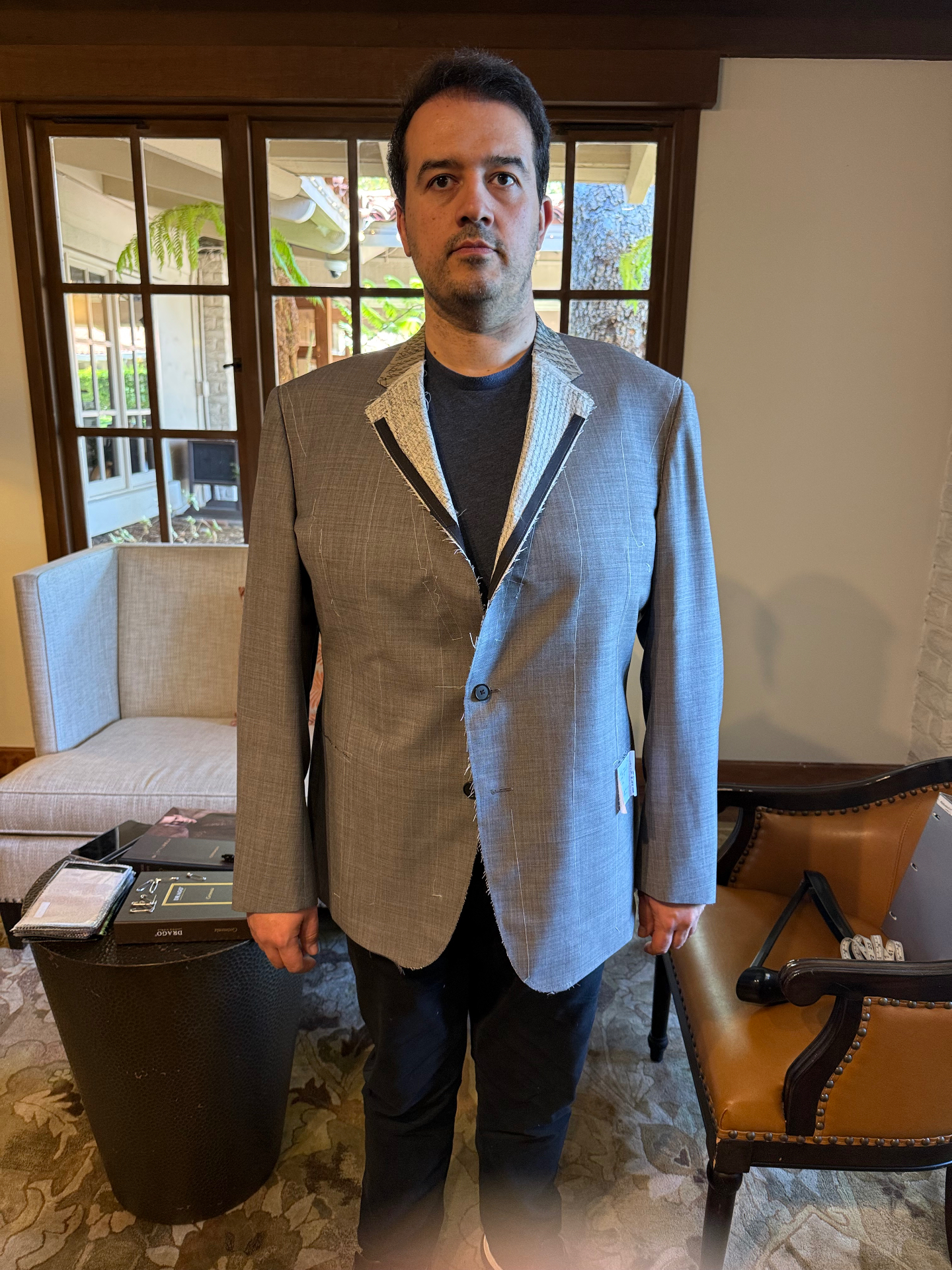 Basted fitting of a gray bespoke wedding jacket with raw canvas lapel