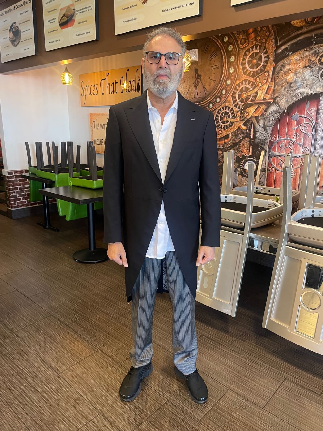 Bespoke Maestro client in a custom black frock-style overcoat