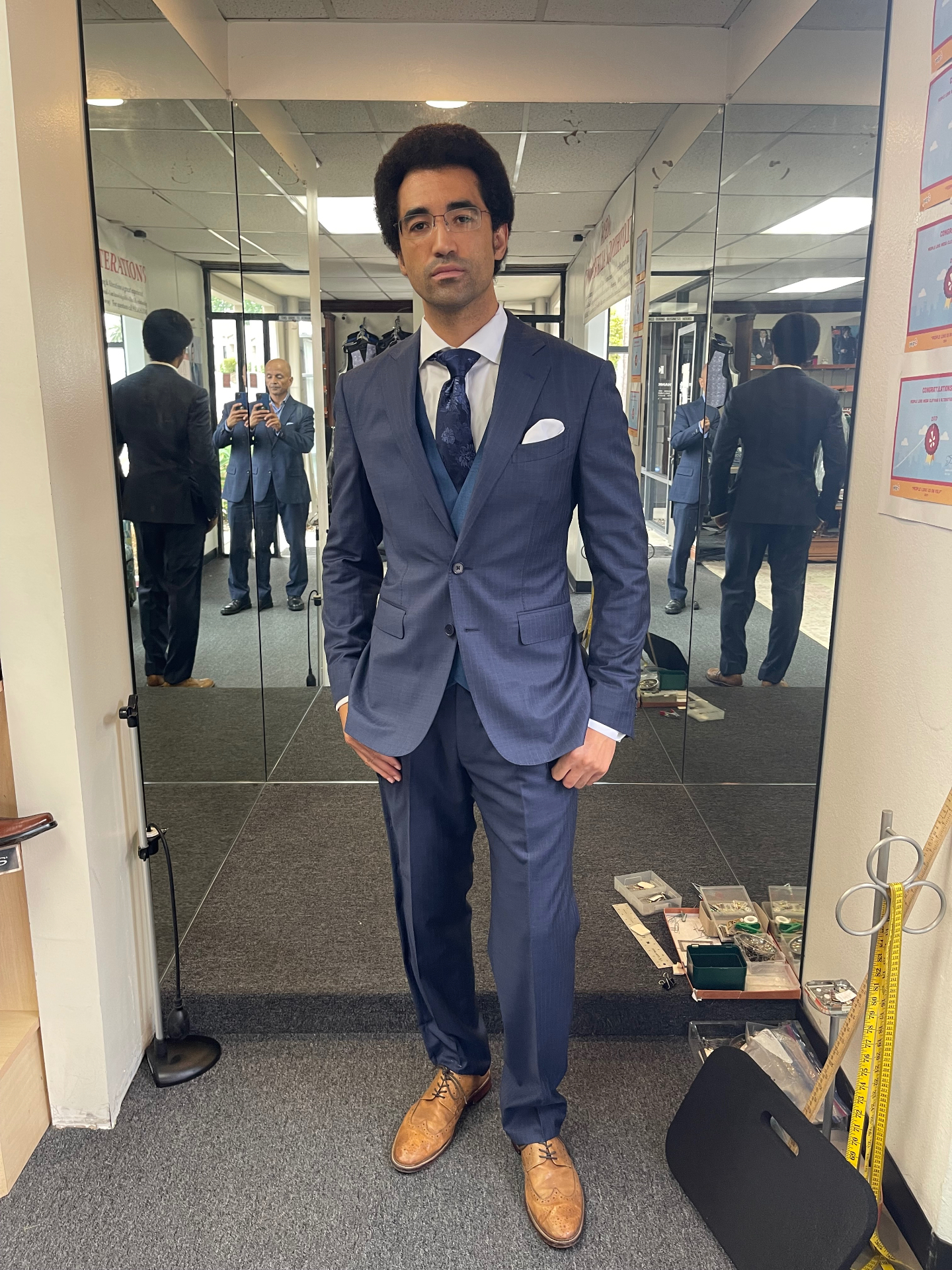Groomsman in a blue three-piece suit with floral tie